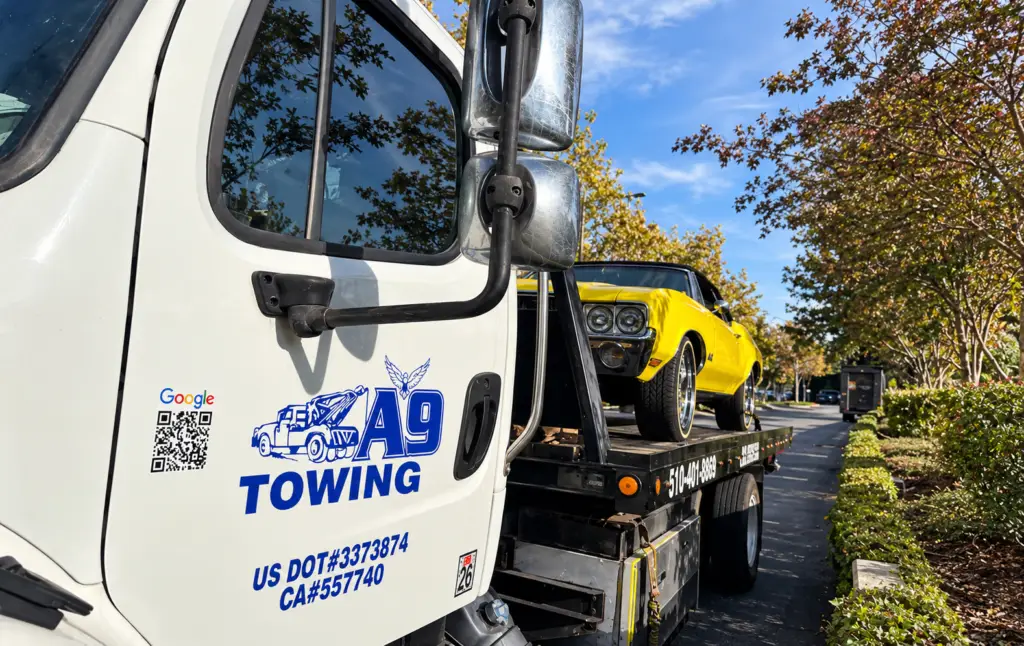 Classic car secured on a flatbed tow truck